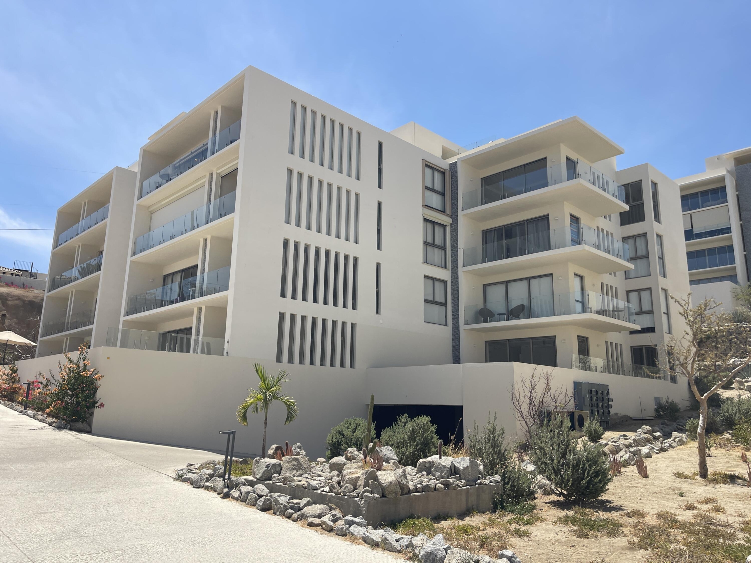Los Cabos Cabo Costa POOL INCLUDED! This stunning 2-bedroom condo with huge deck is located on the first level in the Balandra Tower of Cabo Costa . Cabo Costa is the newest community that blends its arquitectural designs with nature. This unit has been meticulously designed and comprises two end-suite bedrooms. The property interior is designed in neutral tones to create a modern, welcoming and luxurious home yet retaining its original features. Amenities such as a Club House, Infinity pool, Gym, sundeck, Kids area, Jacuzzi, Wetbar, Snackbar & Massage area. – Calle Via La Paloma, Cabo Corridor, BS